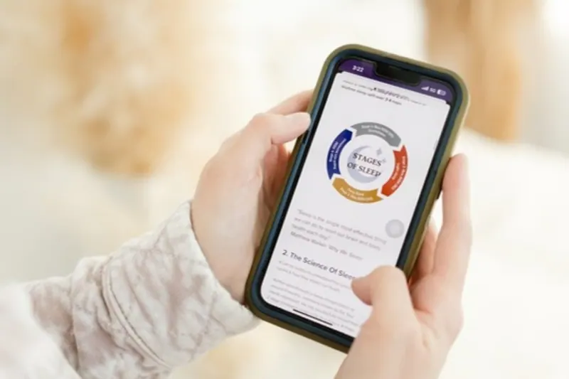 Hands holding a phone showing a Stages of Sleep guide, daily sleep support from your Calgary sleep consultant